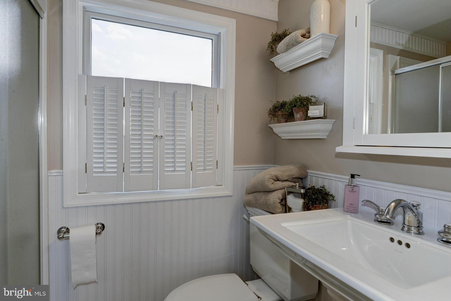 4940 Skinners Neck Road Rock Hall, MD 21661 - Photo 22 of 30 a bathroom with a sink a toilet and vanity