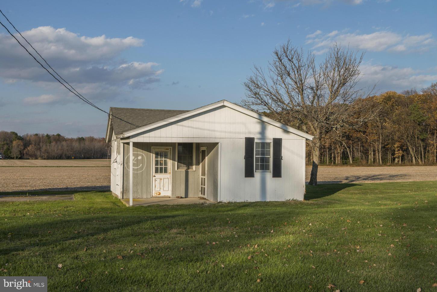 4940 Skinners Neck Road Rock Hall, MD 21661 - Photo 23 of 30 a front view of a house with a garden