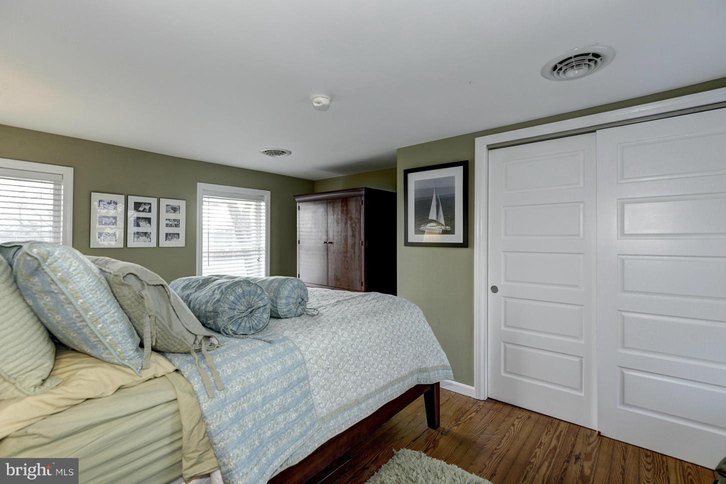 4940 Skinners Neck Road Rock Hall, MD 21661 - Photo 24 of 30 a bedroom with a large bed and a window