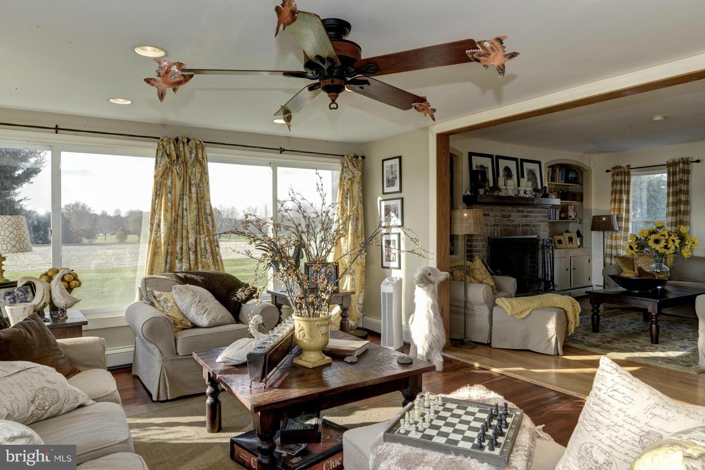 4940 Skinners Neck Road Rock Hall, MD 21661 - Photo 4 of 30 a living room with furniture fireplace and a large window