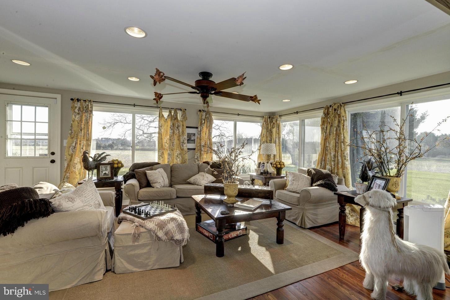 4940 Skinners Neck Road Rock Hall, MD 21661 - Photo 5 of 30 a living room with furniture and a large window