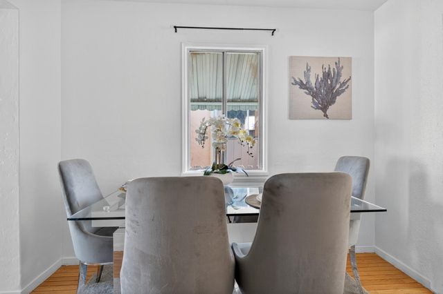 a view of a workspace with furniture and wooden floor