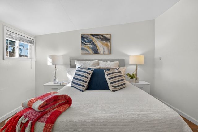 a bedroom with a bed and a lamp