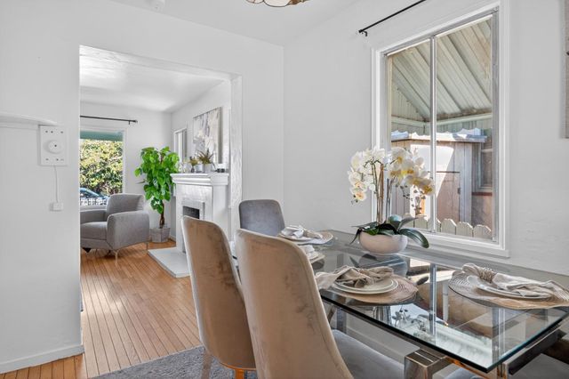 a dining room with furniture window and wooden floor