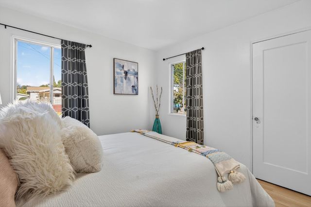 a bedroom with a large bed and a window