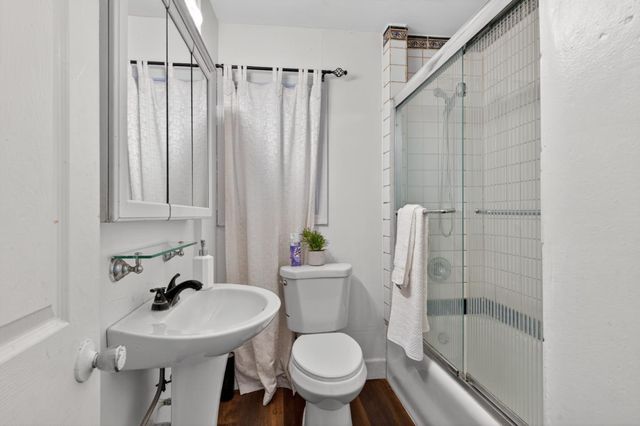 a bathroom with a sink toilet and shower