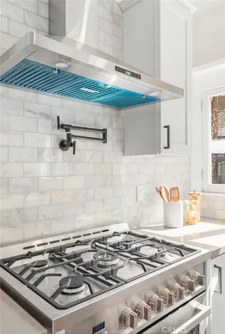 a stove top oven sitting inside of a kitchen