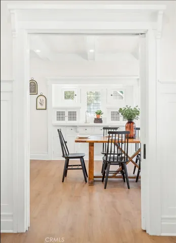 a view of a dining room with furniture and a window