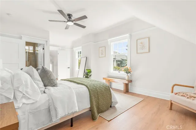 a bedroom with a large bed and a chandelier