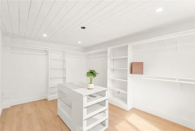 a view of kitchen with white cabinets and wooden floor