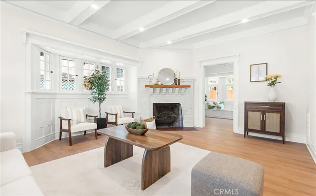 a living room with furniture a fireplace and a large window