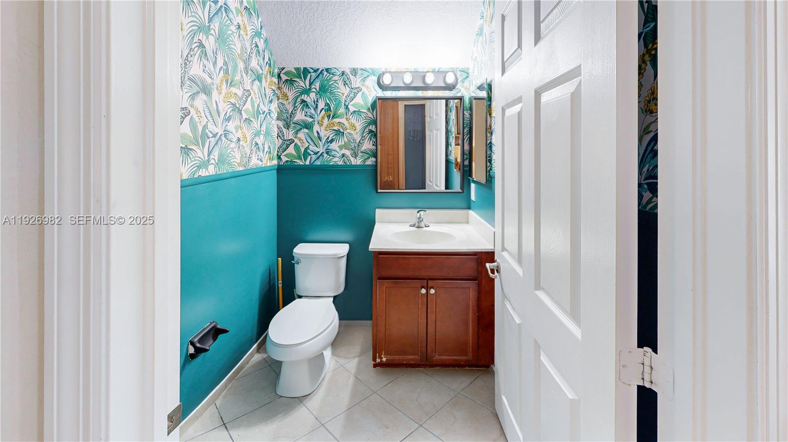 3218 Southeast 5th Court Homestead, FL 33033 - Photo 14 of 68 a bathroom with a toilet sink and mirror