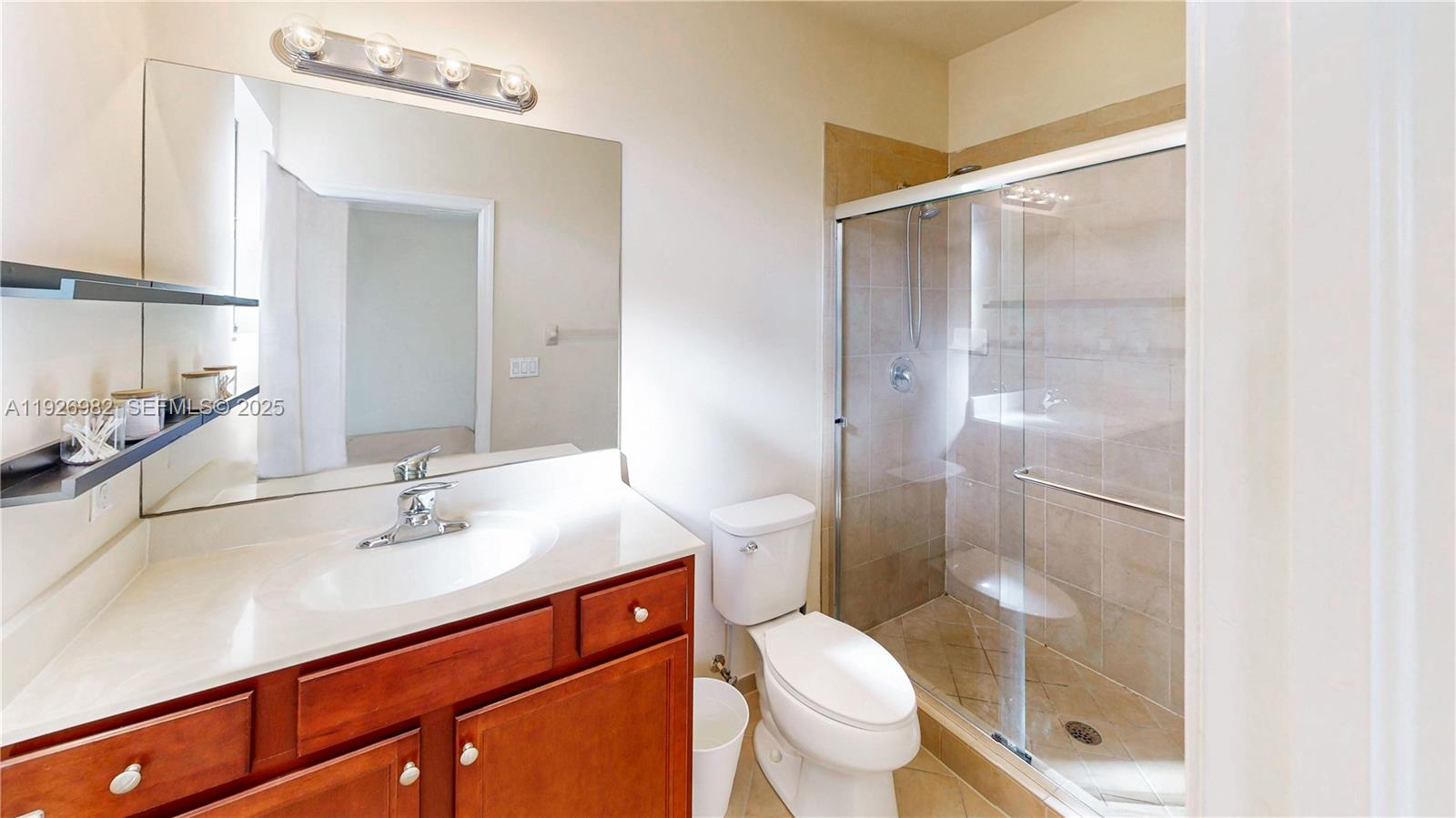 3218 Southeast 5th Court Homestead, FL 33033 - Photo 27 of 68 a bathroom with a sink shower and a toilet