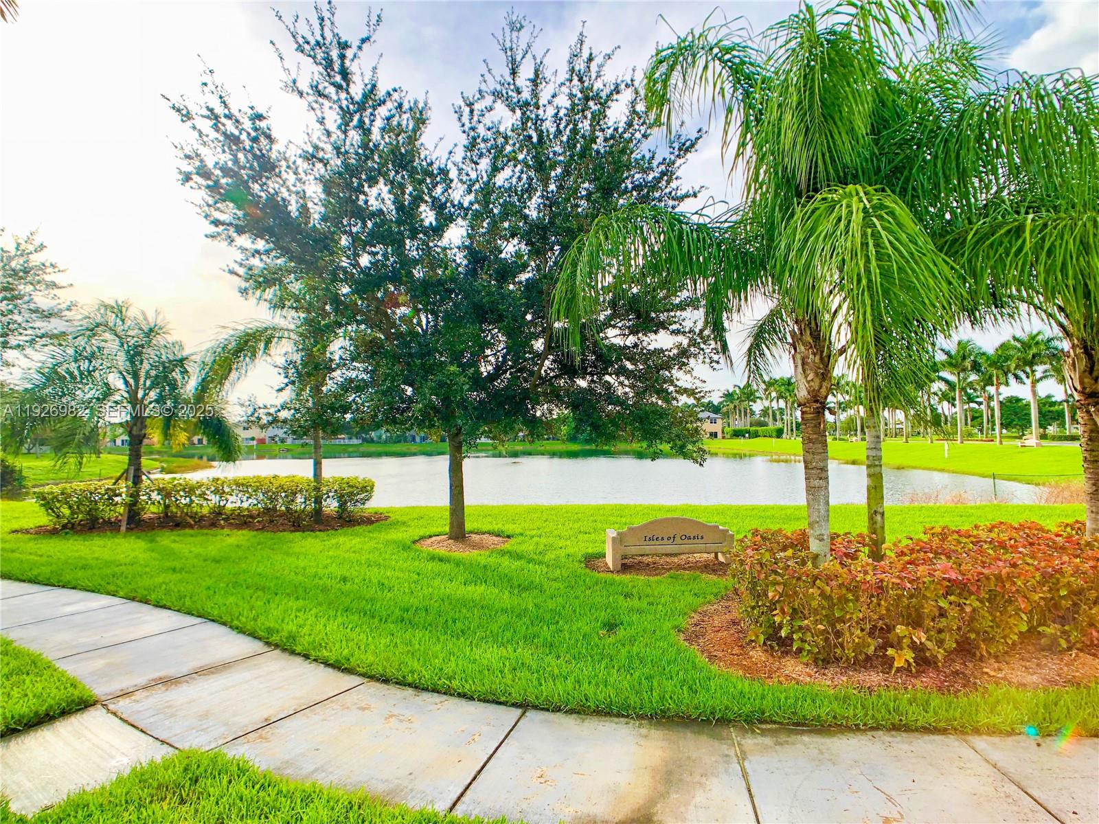 3218 Southeast 5th Court Homestead, FL 33033 - Photo 63 of 68 a view of a swimming pool and trees in the background