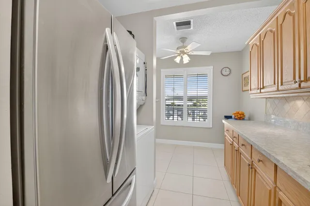 a kitchen with a refrigerator a sink and cabinets