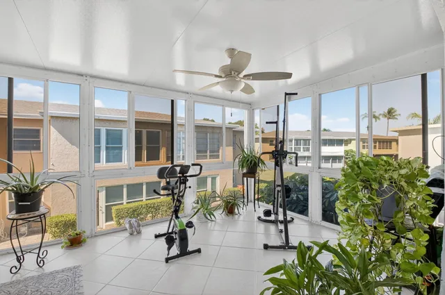a view of a livingroom with furniture and floor to ceiling window