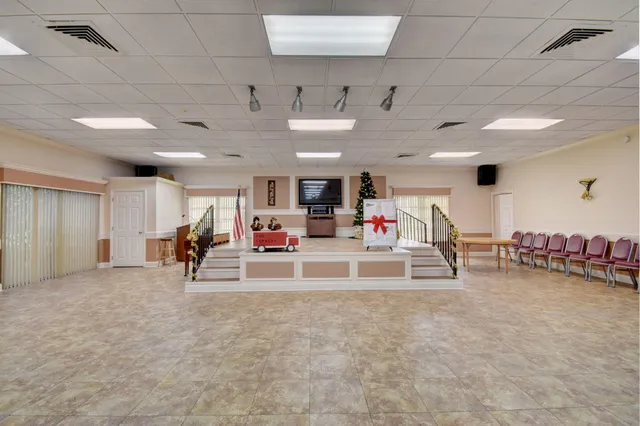 a view of a room with gym equipment and a large window