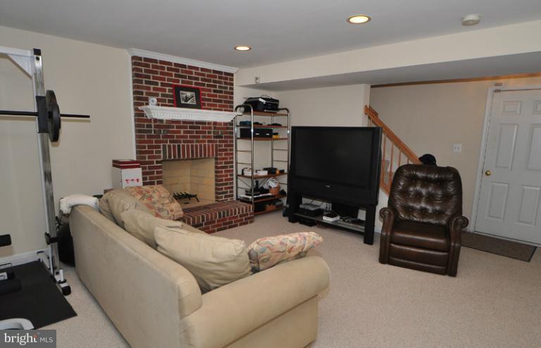 610 Springhouse Square Southeast Leesburg, VA 20175 - Photo 10 of 30 Lower level with brick wood burning fireplace