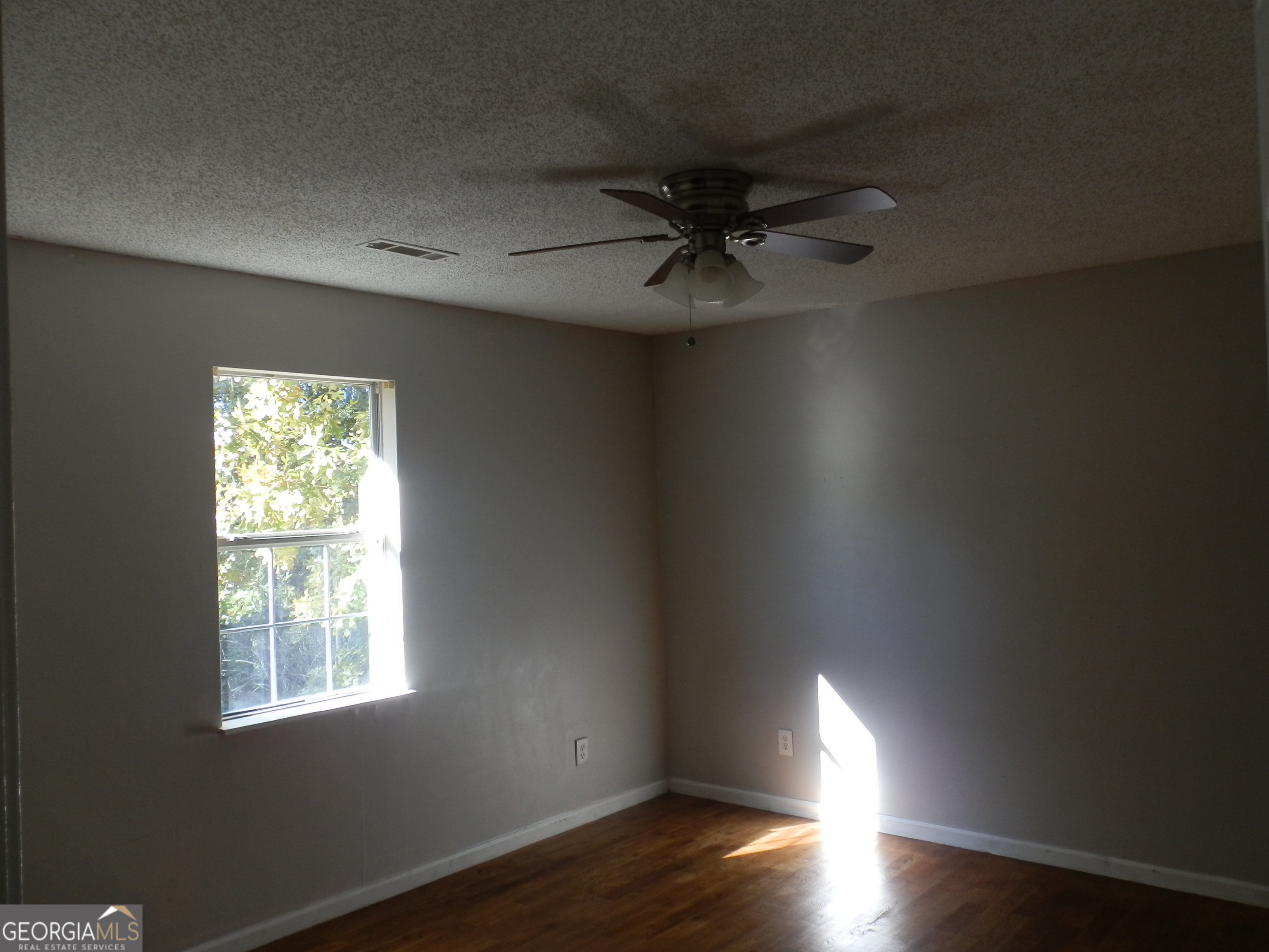 114 Lindsey Court Northeast Calhoun, GA 30701 - Photo 16 of 26 an empty room with wooden floor chandelier fan and windows