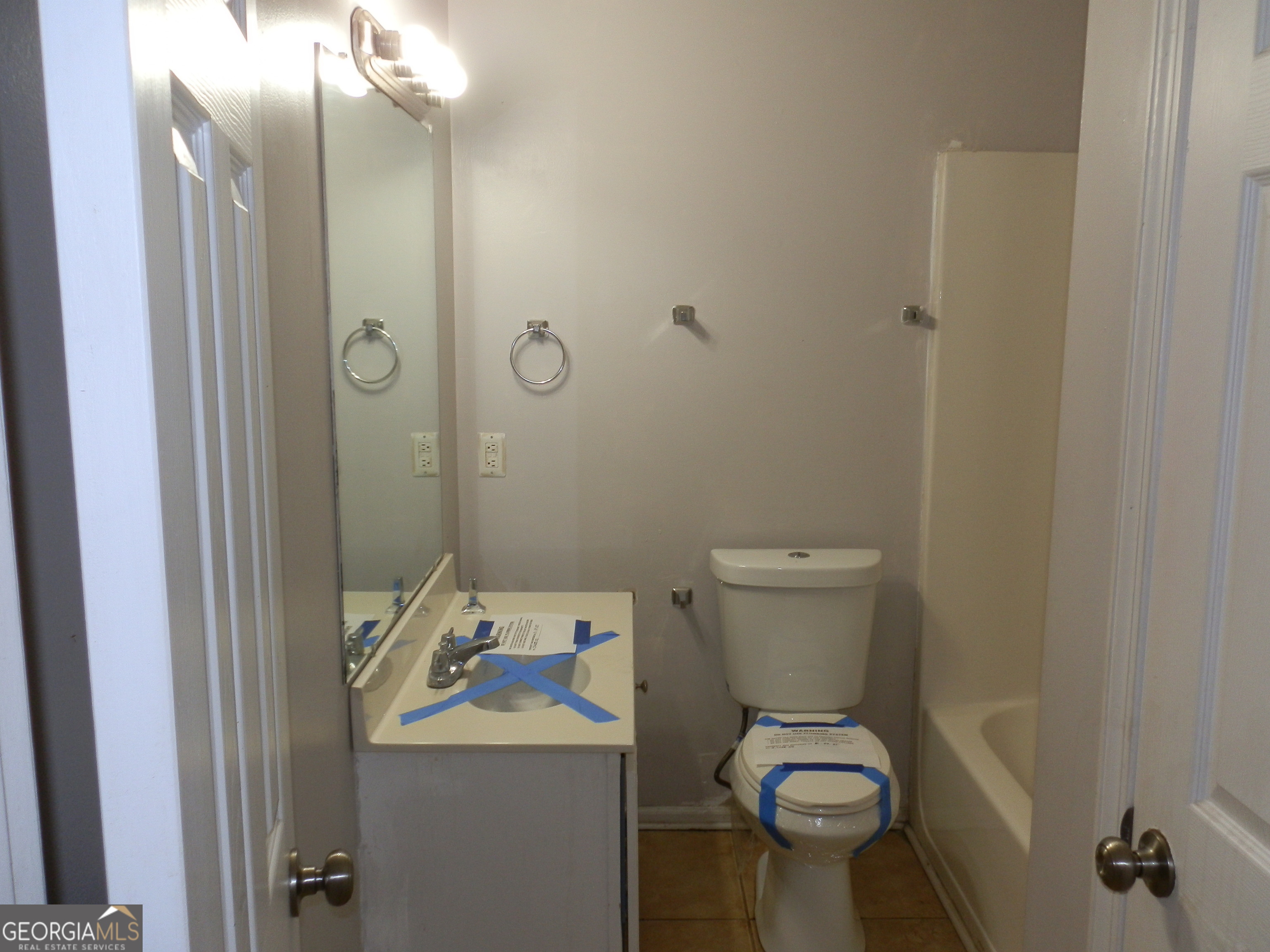 114 Lindsey Court Northeast Calhoun, GA 30701 - Photo 18 of 26 a bathroom with a toilet sink vanity and mirror