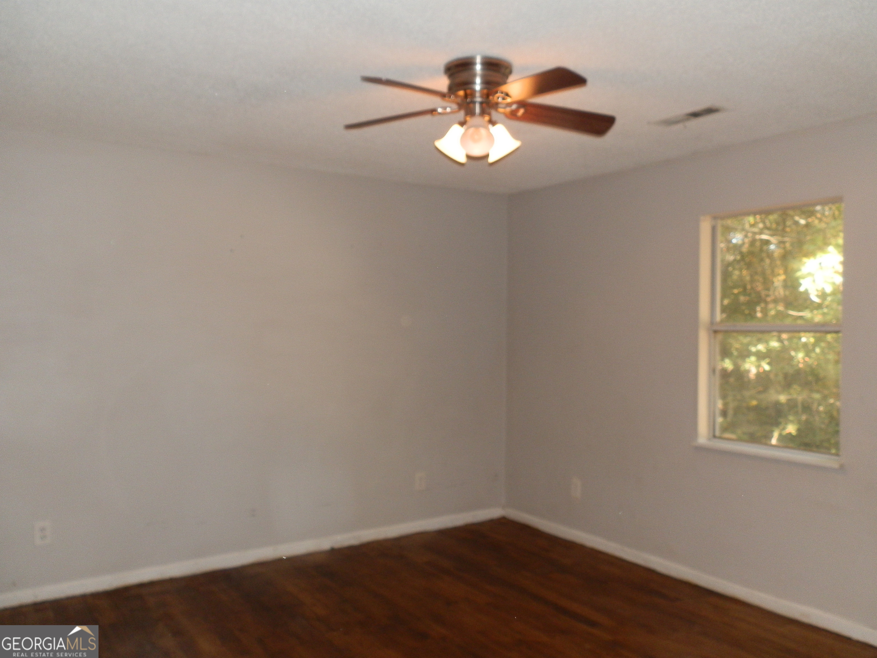 114 Lindsey Court Northeast Calhoun, GA 30701 - Photo 20 of 26 an empty room with wooden floor chandelier fan and windows