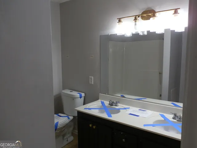a bathroom with a sink vanity and a mirror