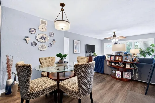 a view of a dining room with furniture and wooden floor