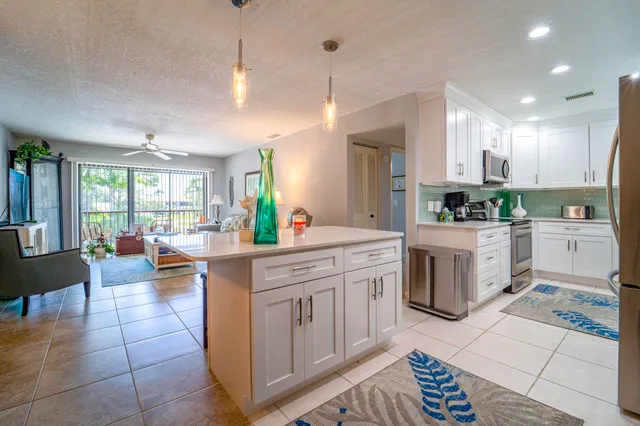 a kitchen with a sink counter top space appliances and cabinets