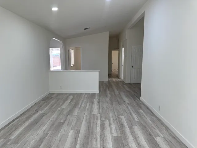 a view of a room with wooden floor