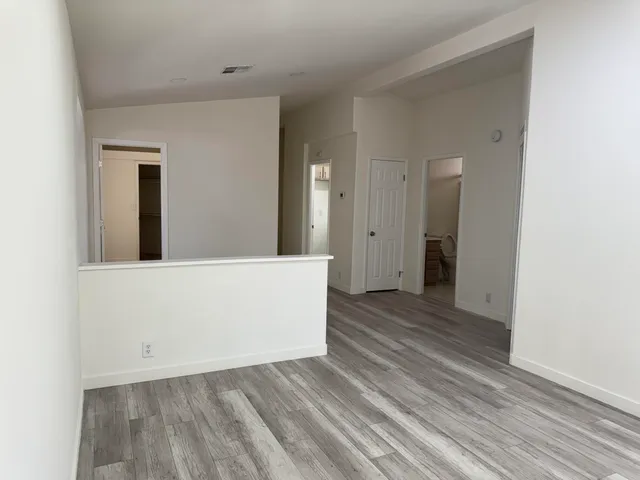a kitchen with white cabinets and sink