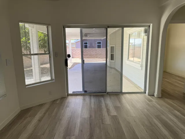 a view of a kitchen with wooden floor and a window