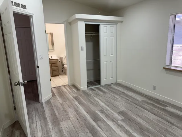 a bathroom with a shower a mirror and a sink