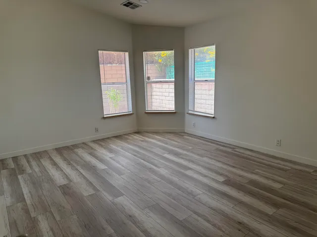 a view of empty room with closet and window