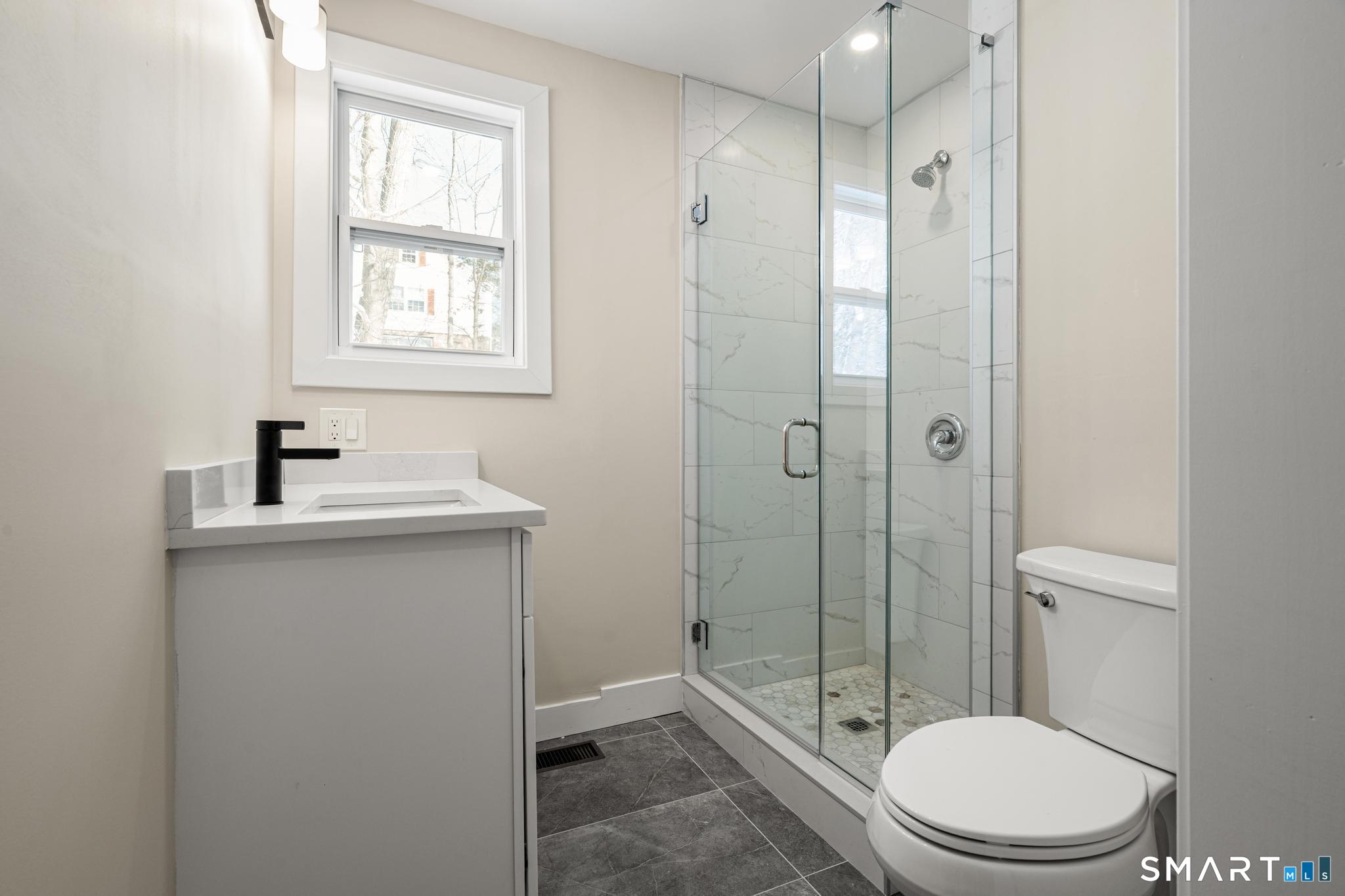 6 Juniper Ridge Drive Danbury, CT 06811 - Photo 22 of 36 a bathroom with a toilet a sink and shower