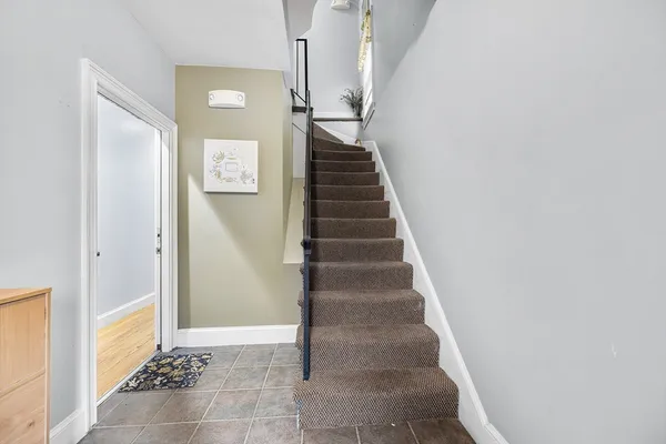 a view of entryway and hall with wooden floor