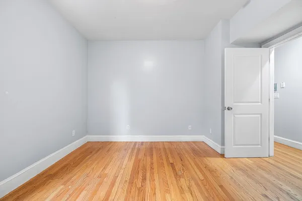 a view of a room with wooden floor