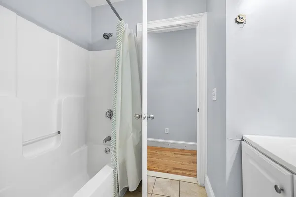 a bathroom with a bathtub and a shower