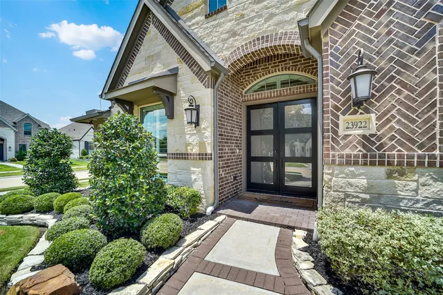 a front view of a house with a lots of plants