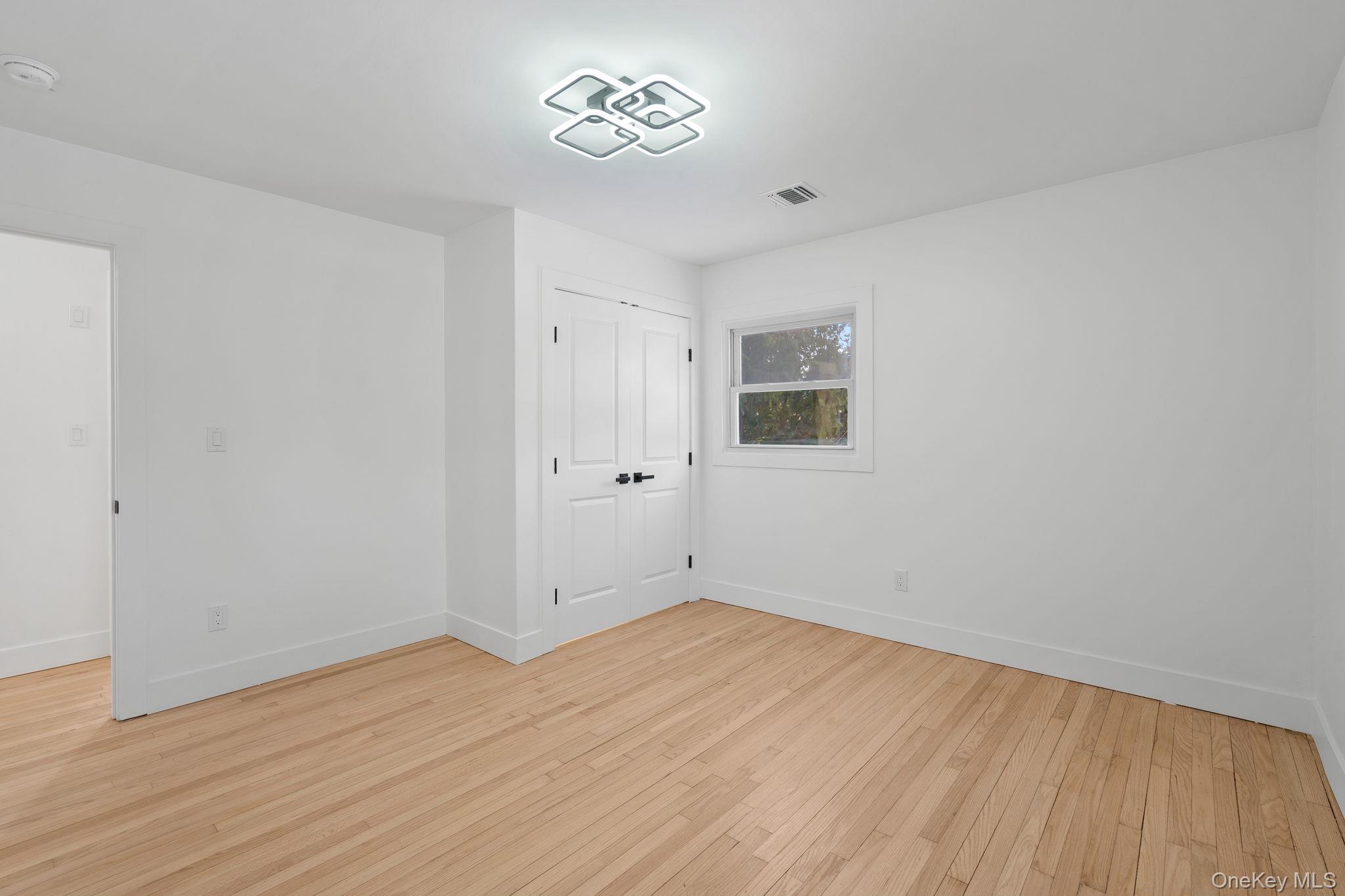 52 Rudolph Road Modena, NY 12548 - Photo 16 of 49 Unfurnished bedroom with light wood-style flooring and a closet