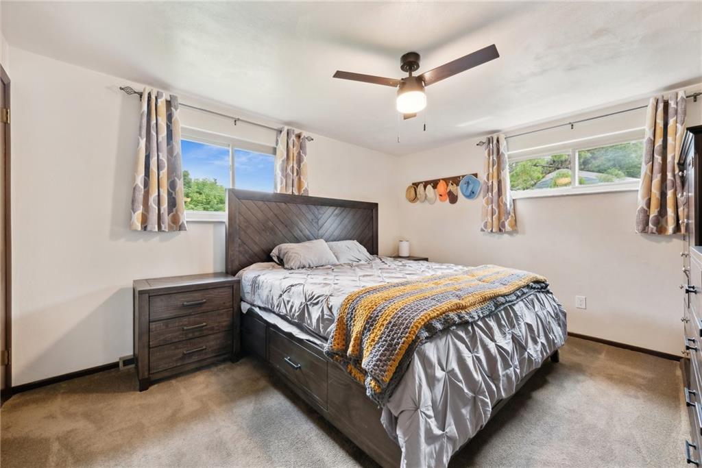 101 Edith Drive Hunker, PA 15639 - Photo 14 of 35 a bedroom with a bed a window and a ceiling fan