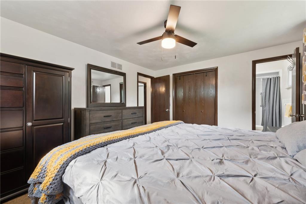 101 Edith Drive Hunker, PA 15639 - Photo 15 of 35 a bedroom with a bed and a chandelier