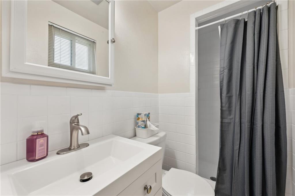 101 Edith Drive Hunker, PA 15639 - Photo 16 of 35 a bathroom with a sink a toilet and a mirror