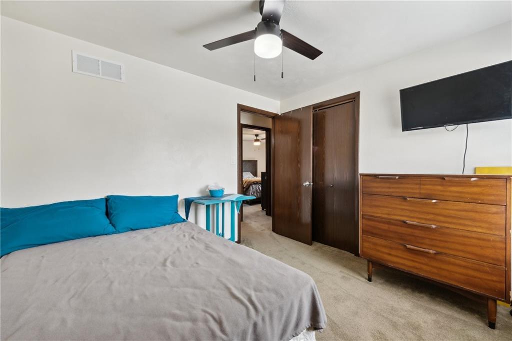 101 Edith Drive Hunker, PA 15639 - Photo 20 of 35 a bedroom with a bed and a flat tv screen on dresser