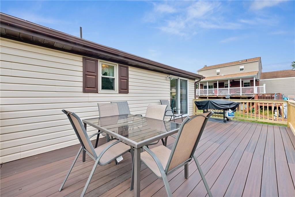 101 Edith Drive Hunker, PA 15639 - Photo 29 of 35 a view of a roof deck with table and chairs and wooden floor