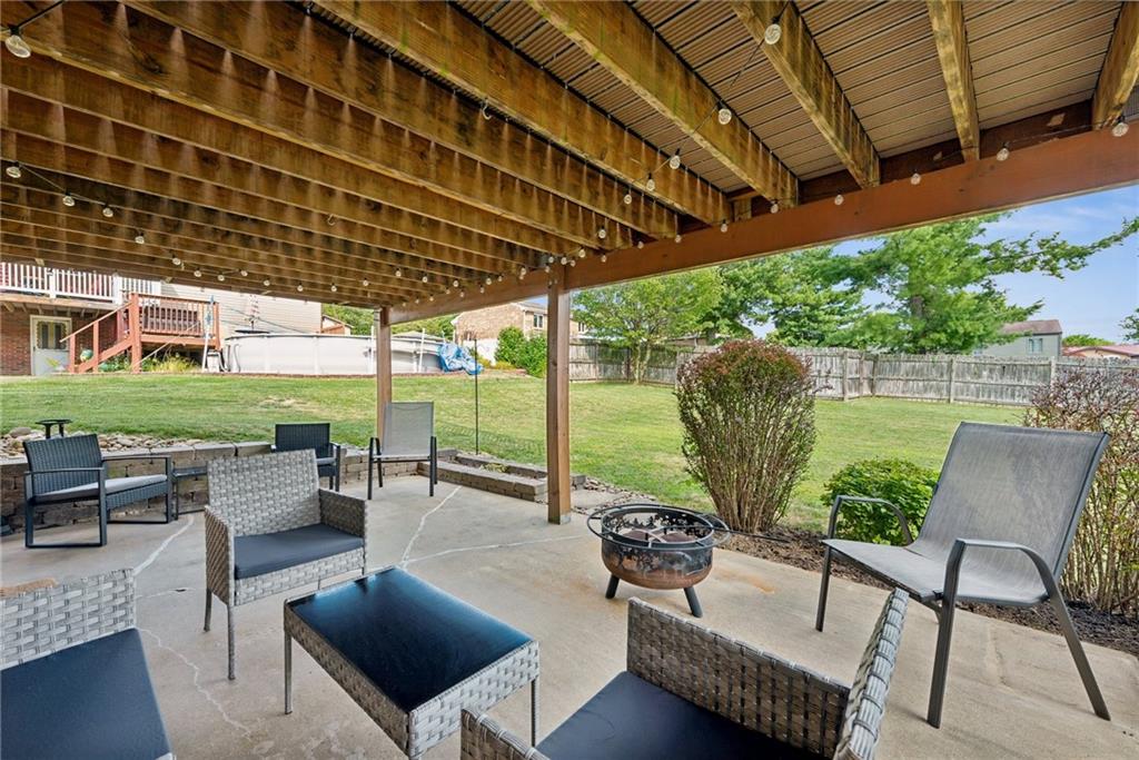 101 Edith Drive Hunker, PA 15639 - Photo 32 of 35 a view of a patio with couches chairs dining table and chairs with wooden floor