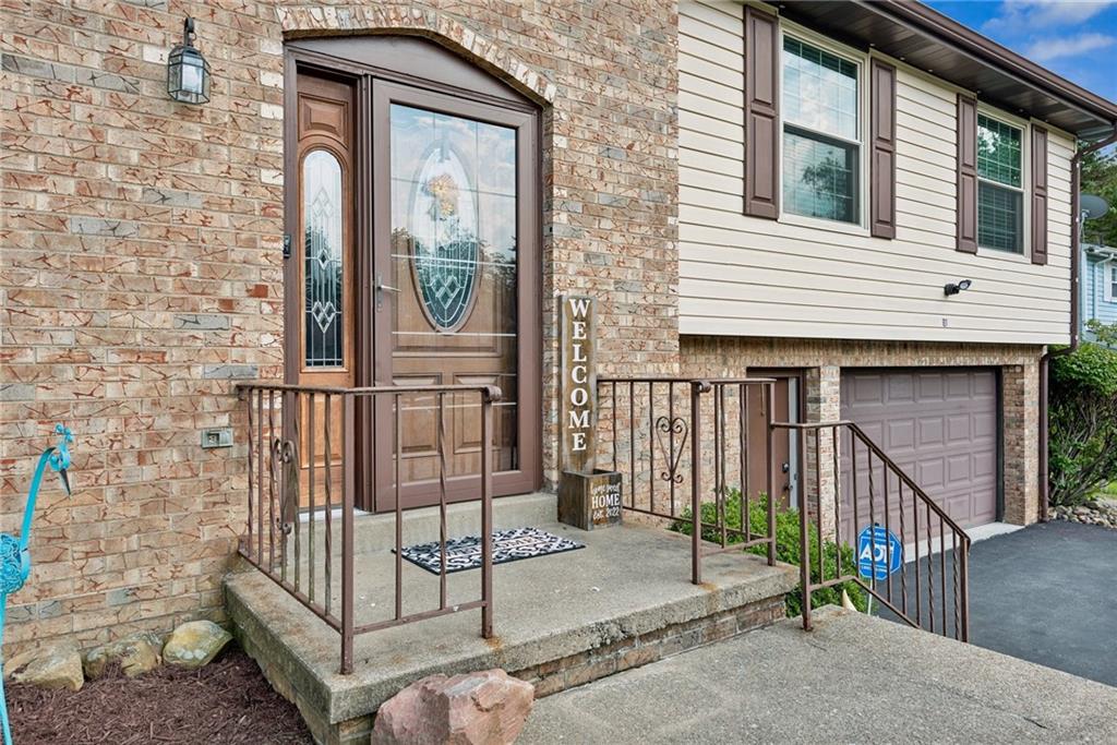 101 Edith Drive Hunker, PA 15639 - Photo 4 of 35 a view of a brick house with large windows
