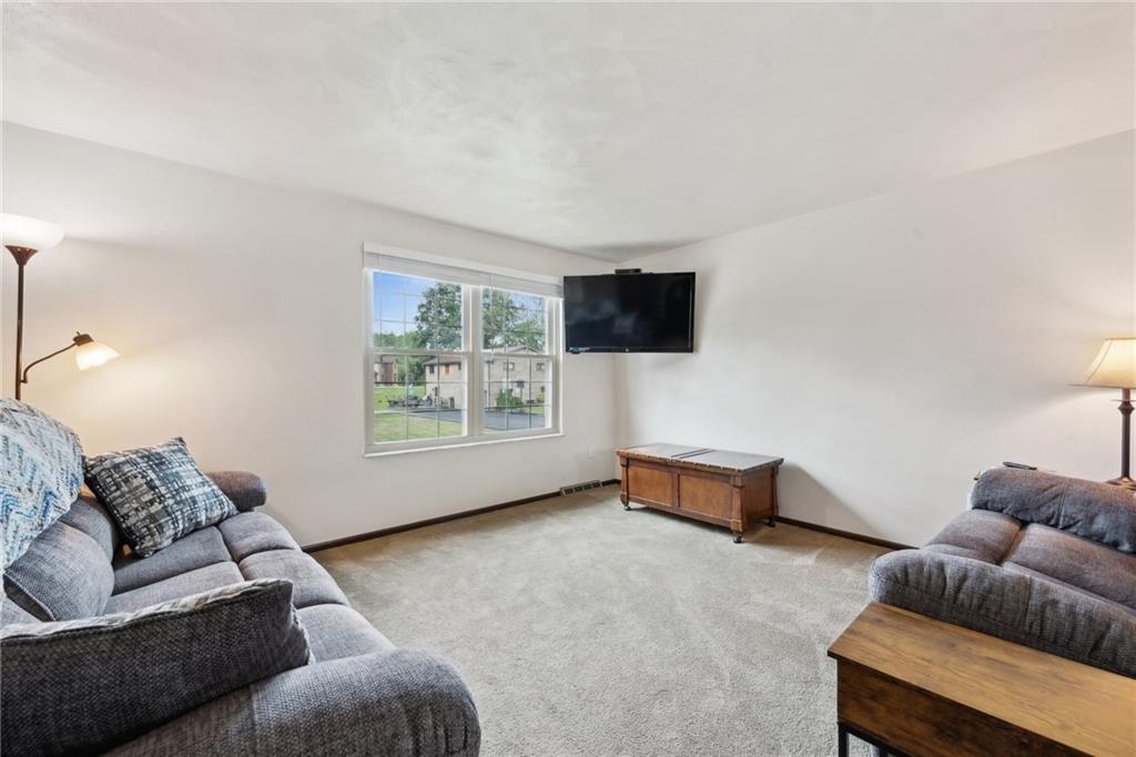 101 Edith Drive Hunker, PA 15639 - Photo 5 of 35 a living room with furniture and a flat screen tv