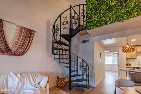 a view of entryway and hall with wooden floor