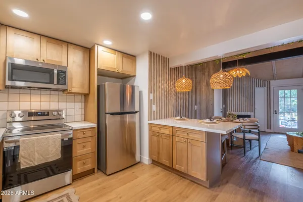 a kitchen with a sink stove and refrigerator