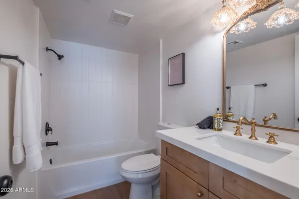 a bathroom with a sink toilet a mirror and shower